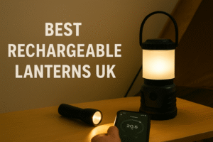 Featured image showing a rechargeable camping lantern glowing on a wooden surface beside a flashlight and a smartphone. A tent wall is visible in the background. Bold text on the left reads “Best Rechargeable Lanterns UK.” Warm, low-light scene suitable for power cuts or camping.